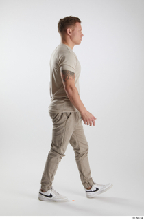 Gilbert 1 dressed grey t-shirt grey trousers side view walking…